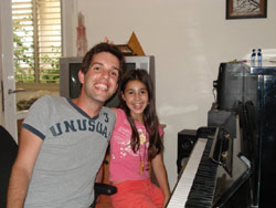 Me (David) and Ariel (My Piano Student) next to the piano.