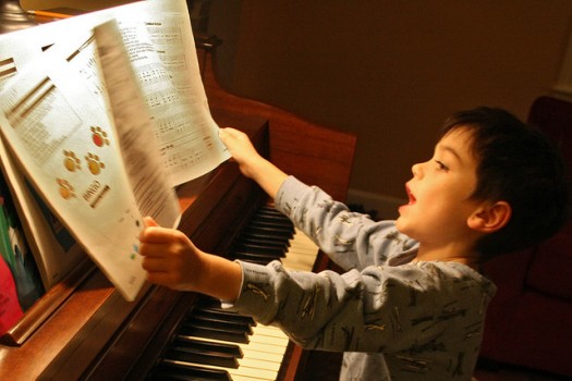 An image of a child learning piano